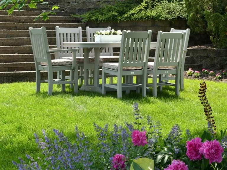 white wooden dining table with chairs set on grass